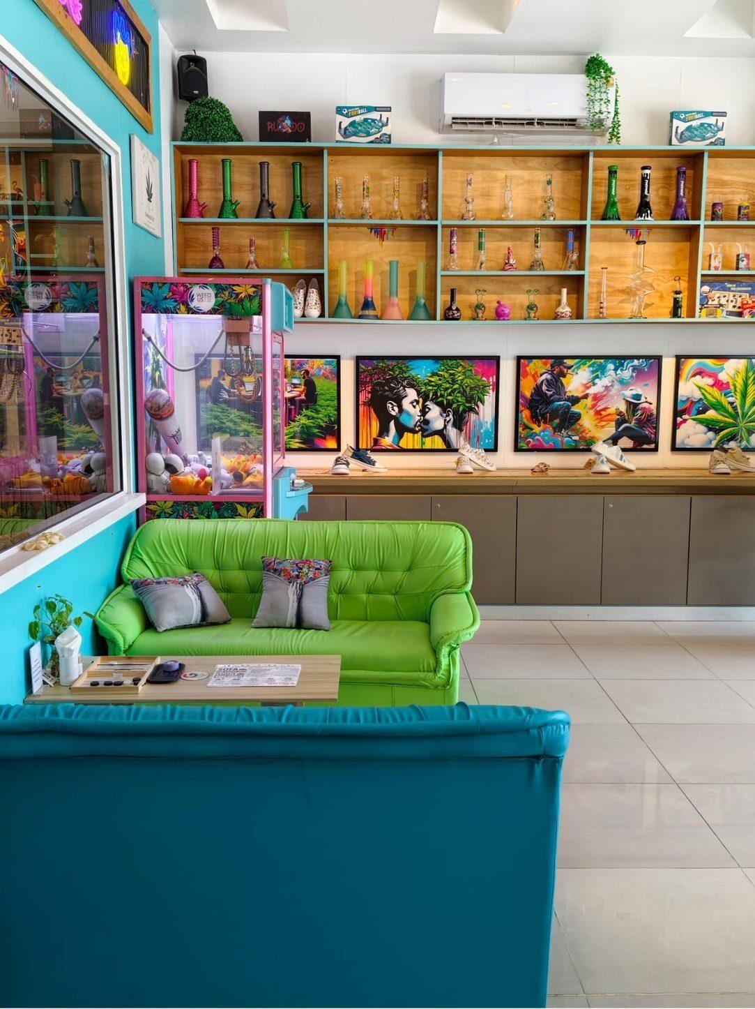 Weed Us — colourful mural lounge with green and teal couches