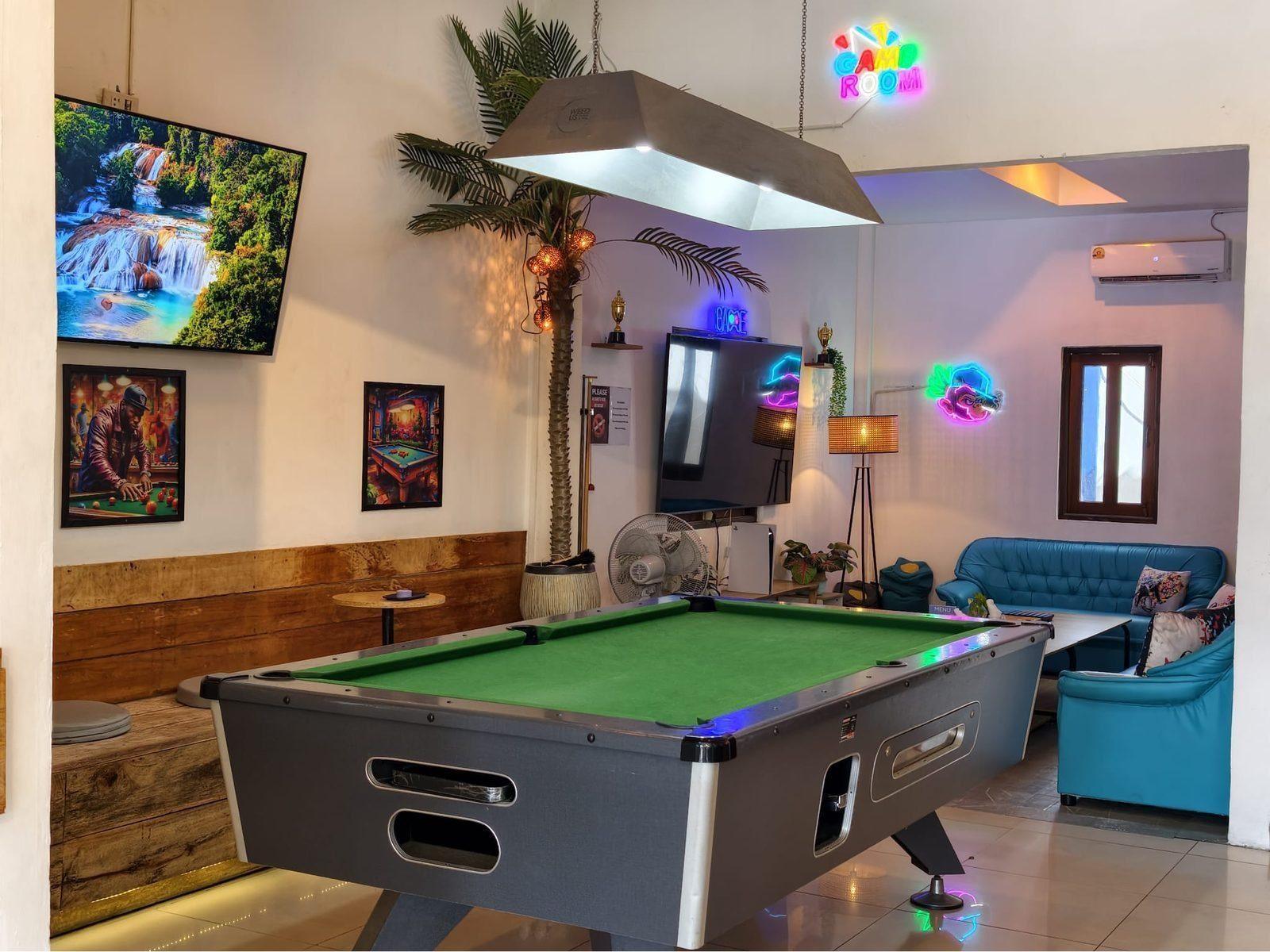 Weed Us — pool table room with ambient neon lighting