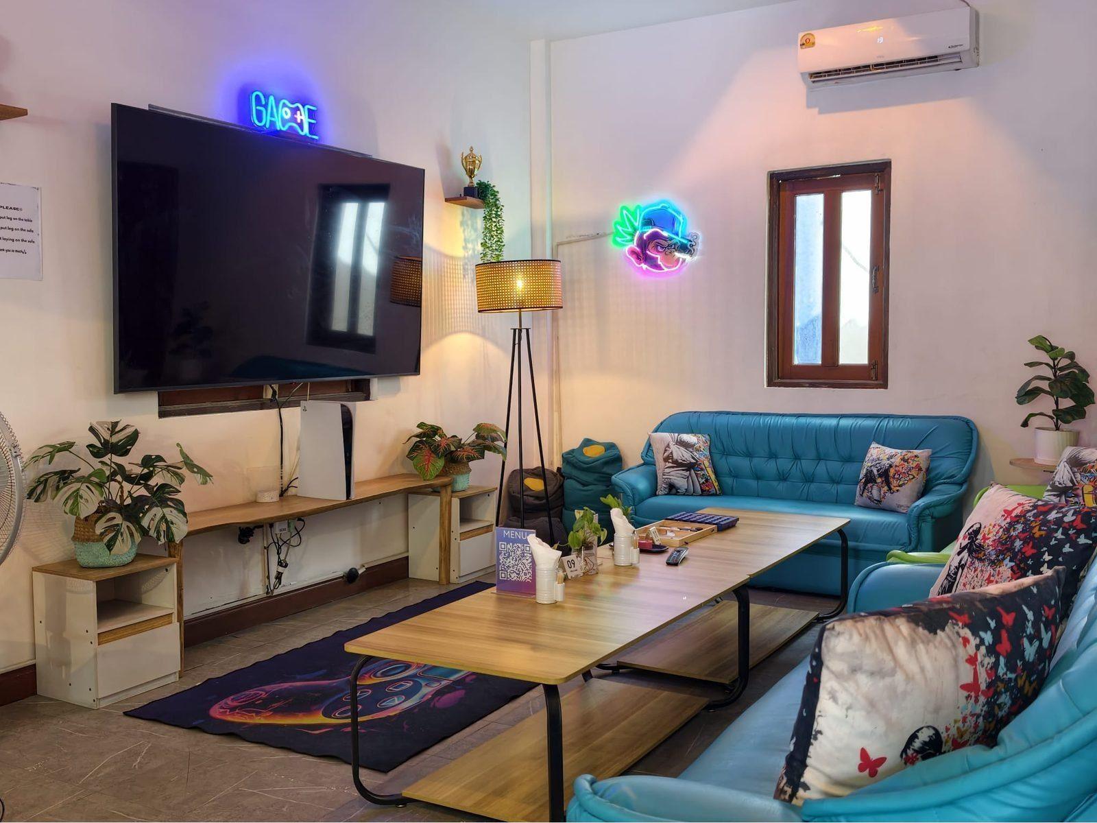 PS5 Gaming lounge at Weed Us — TV, couches and neon lights